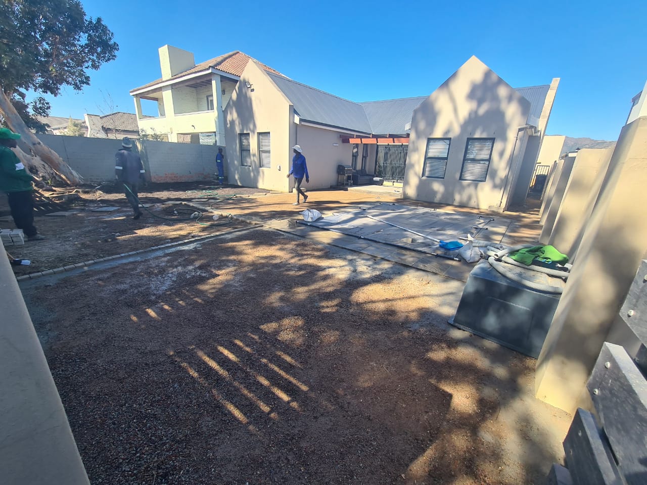 Fresh green turf being rolled out.